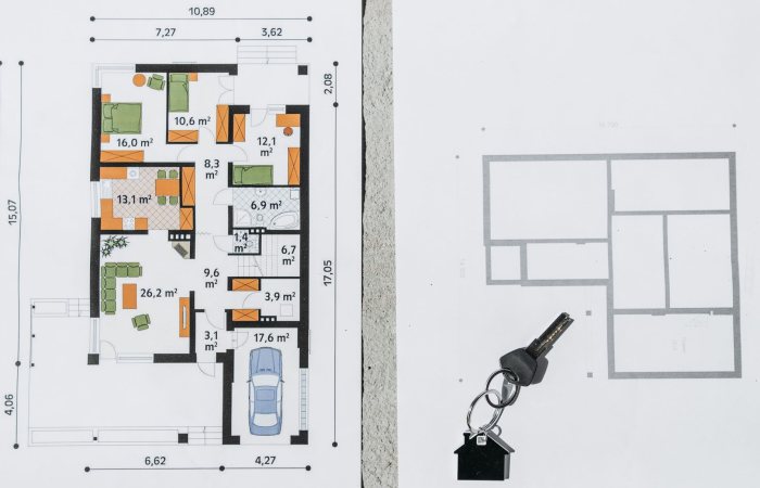 A comprehensive floor plan layout featuring a house key symbolizing real estate and homeownership.