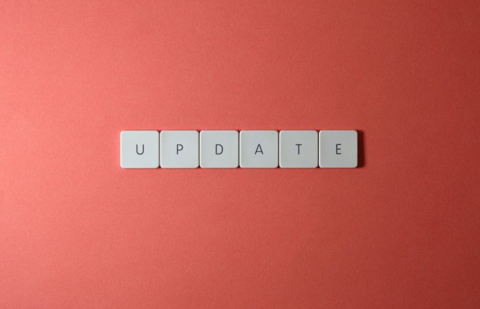 Keyboard keys arranged to spell 'update' on a vibrant red background, ideal for conveying tech concepts.
