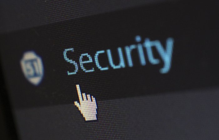 Close-up view of a mouse cursor over digital security text on display.
