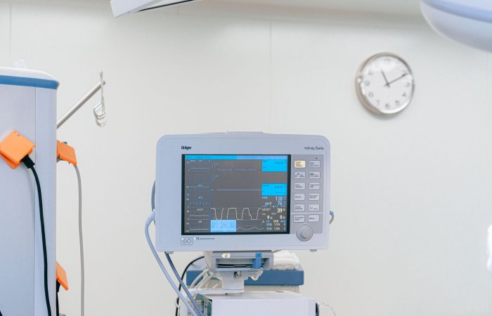 A modern heart rate monitor in a sterile hospital setting, showcasing medical technology.