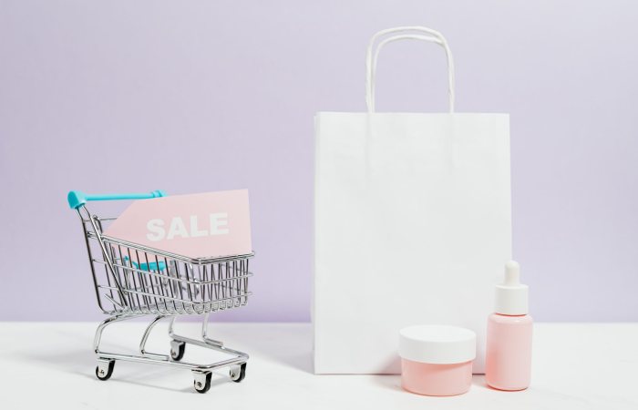 Aesthetic shopping scene with a white bag, cart, and cosmetics on sale.