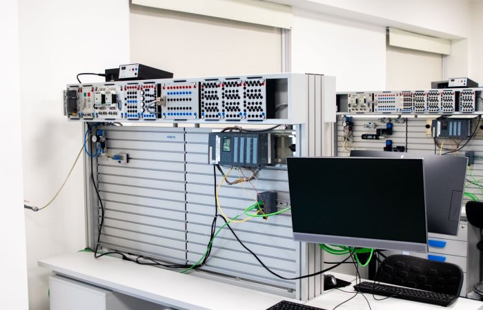 A contemporary office showcasing a server rack and computer workspace, ideal for tech and business settings.